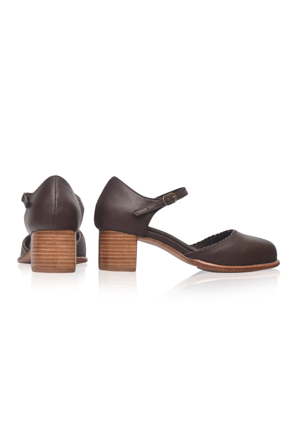 A pair of dark brown leather Mary Jane style shoes with block heels, shown from the side and back on a white background.