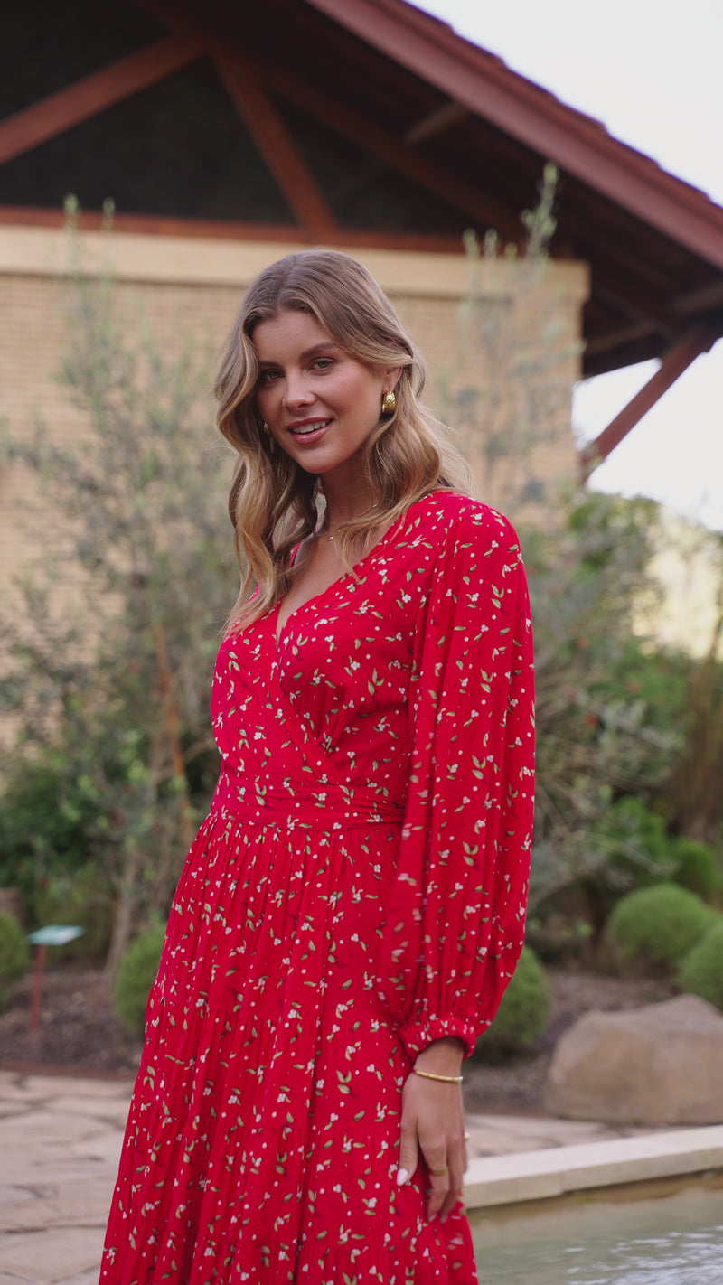 Video of woman wearing red floaty wrap dress with long sleeves